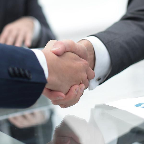 handshake business colleagues in office